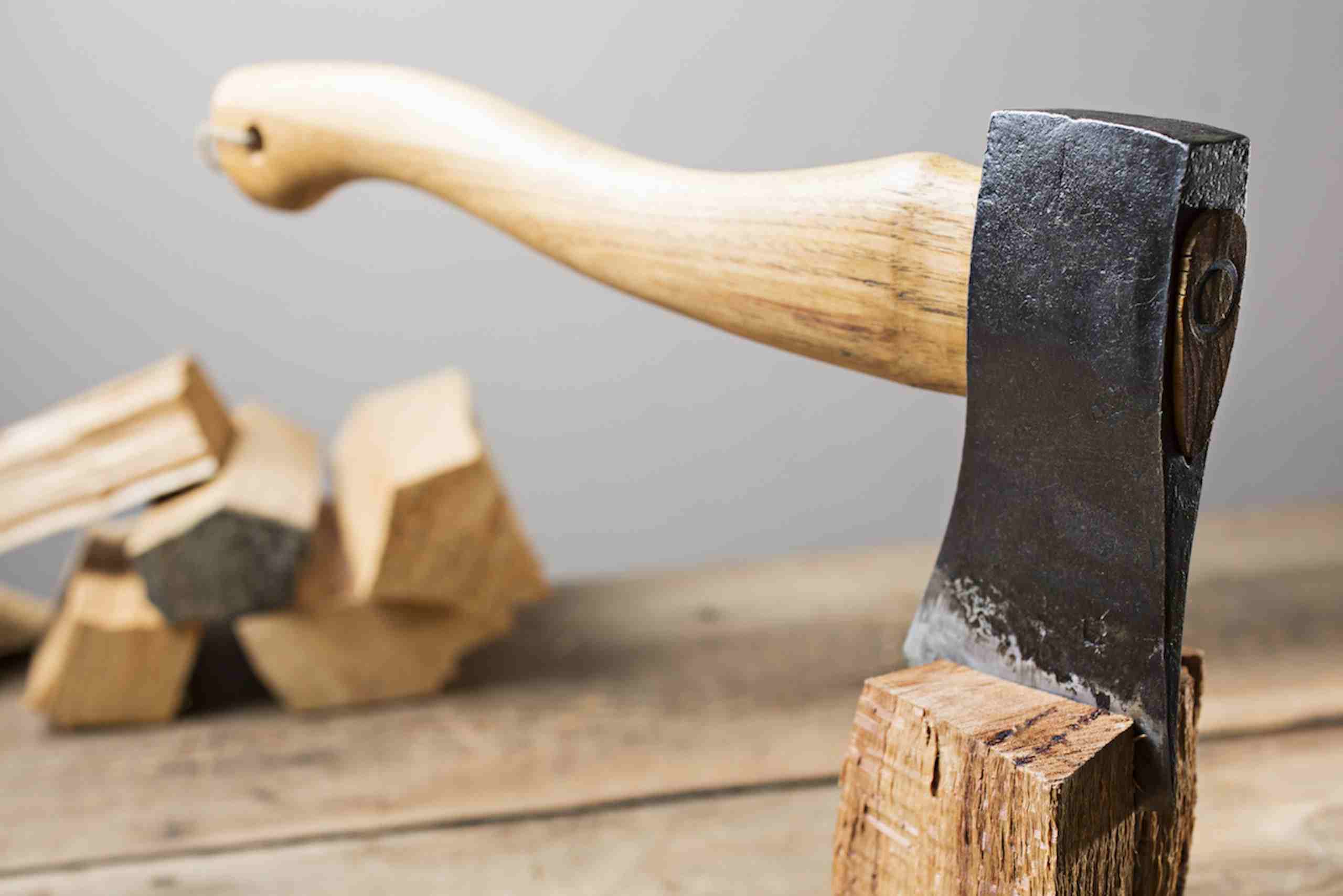 Old wooden handle axe in a block of wood